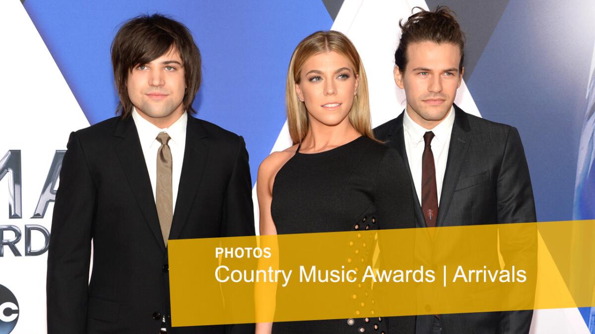 Neil Perry, left, Kimberly Perry and Reid Perry, of the Band Perry, arrive at the CMA Awards.