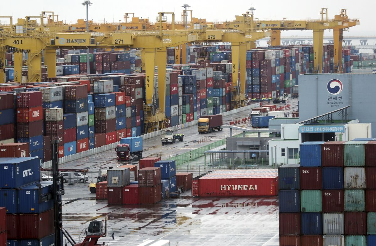 Cargo trucks transport containers at a container terminal in Incheon, South Korea, Wednesday, June 15, 2022. Truckers in South Korea ended an eight-day strike that caused major disruptions to domestic production and cargo transport, their union and the government announced after negotiations Tuesday. (Yun Tae-hyun/AP via AP)