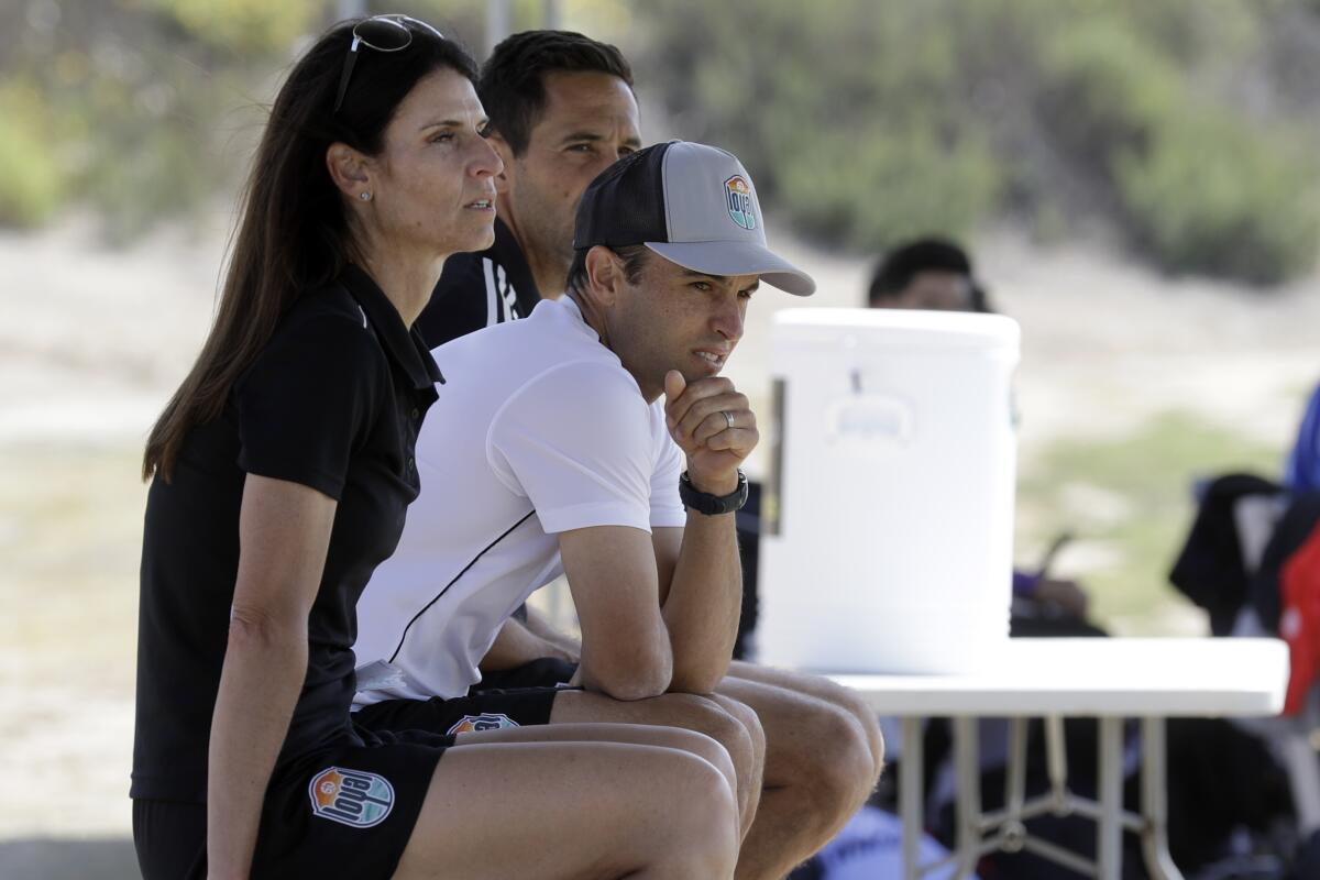 Landon Donovan sits between assistant coaches Nate Miller and Carrie Taylor during a scrimmage on Wednesday in Chula Vista.