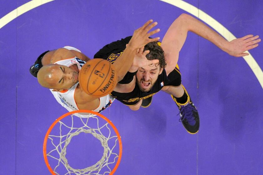 The Lakers' Pau Gasol tries to score inside against the Charlotte Bobcats' Gerald Henderson during a game at Staples Center.