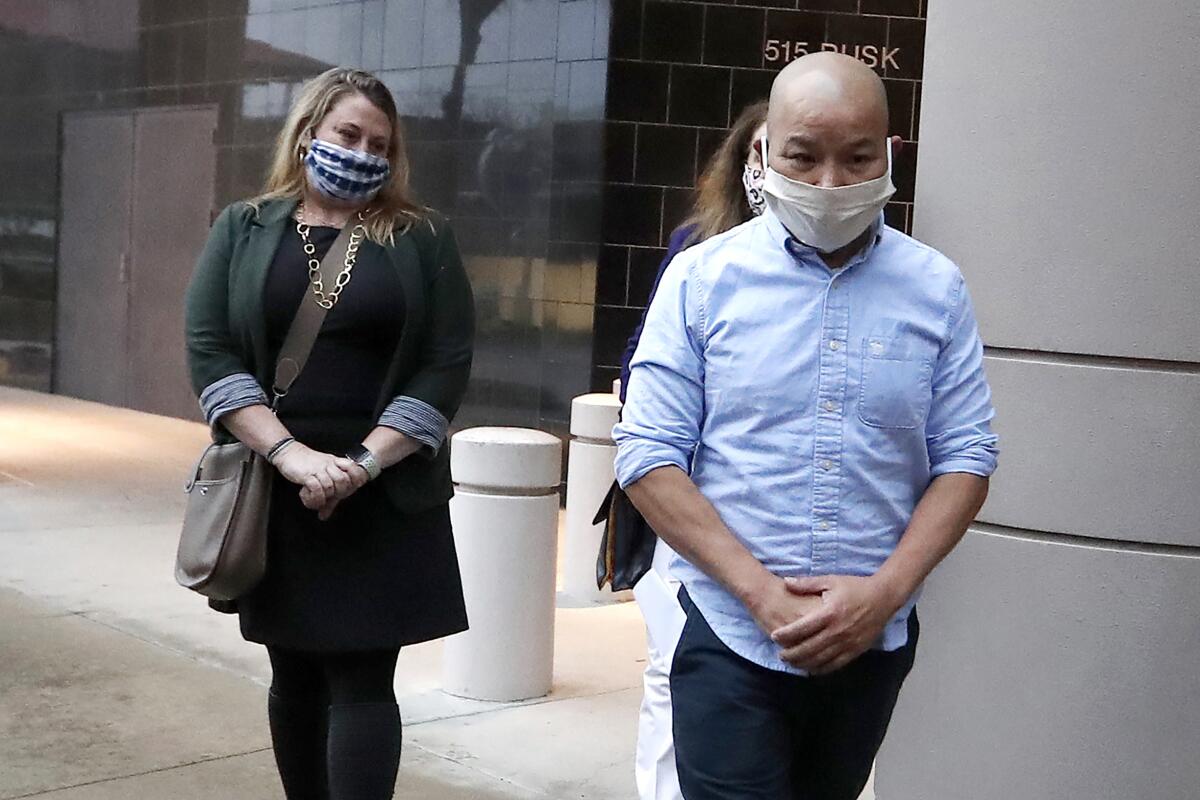 Former Houston police Officer Tam Pham walks out of the Federal Courthouse downtown in Houston with two women. 