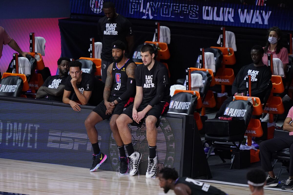 Clippers players sit on the bench during the second half of their Game 7 playoff loss to the Denver Nuggets.