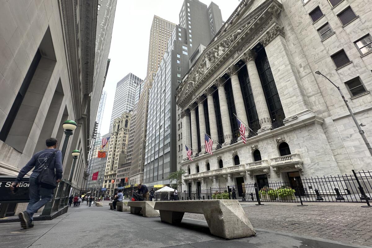 People walk near the New York Stock Exchange.