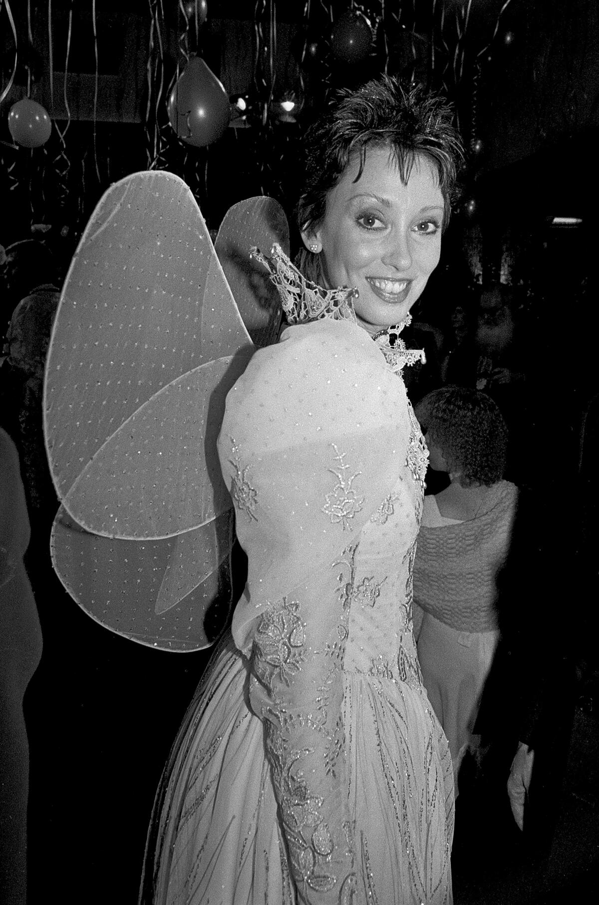 Shelley Duvall wearing a set of fairy wings in 1985.