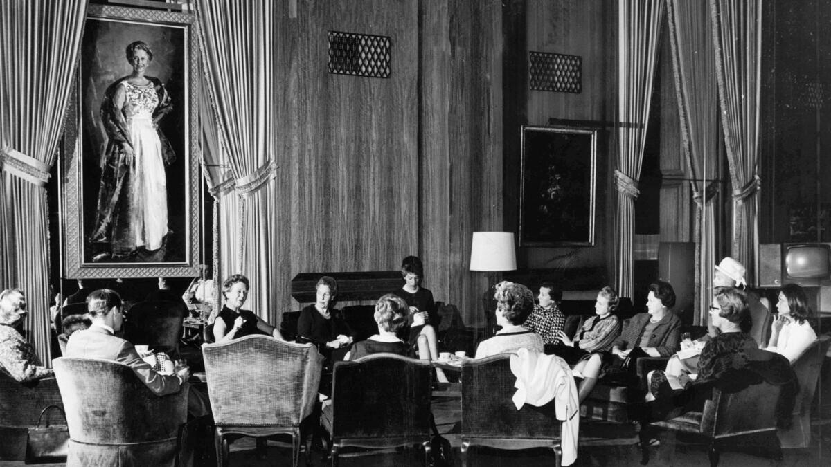 Dorothy Chandler under her portrait on the wall at a meeting held in The Founders Room of the Dorothy Chandler Pavilion on March 28, 1967.