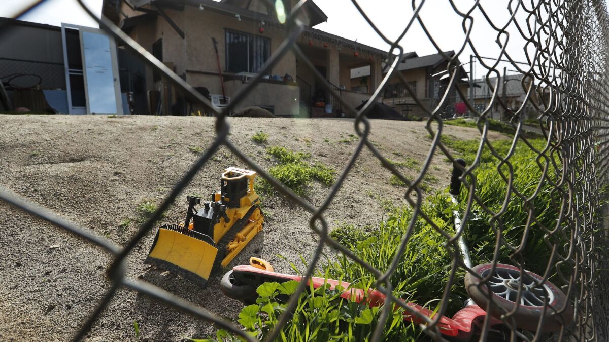 Children's toys are seen in the frontyard of a home on Sabina Street in Boyle Heights where soil tests detected lead contamination in July 2016. The levels were high enough to qualify the property for cleanup.