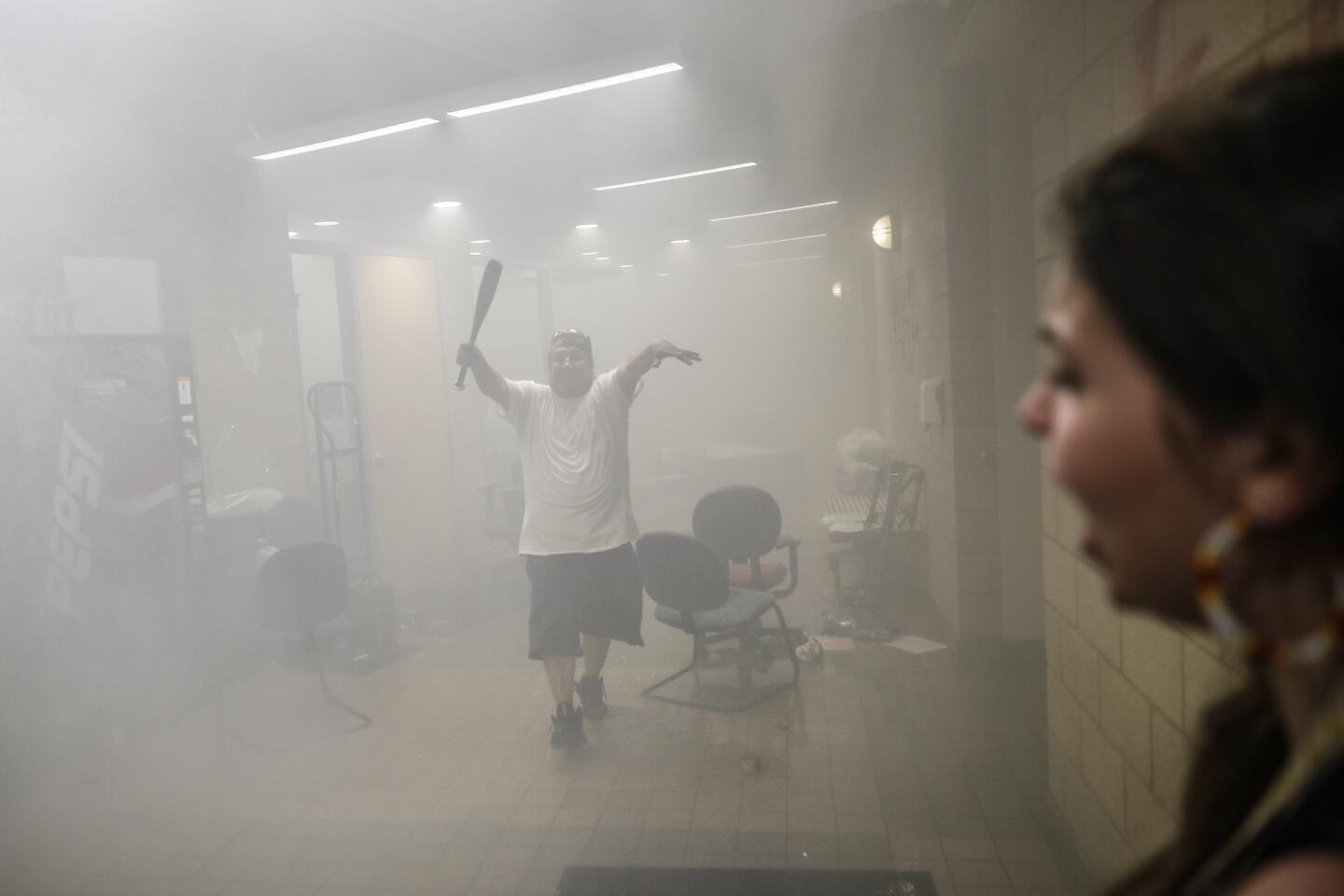 Protesters enter a smoke-filled part of Minneapolis' 3rd Police Precinct.