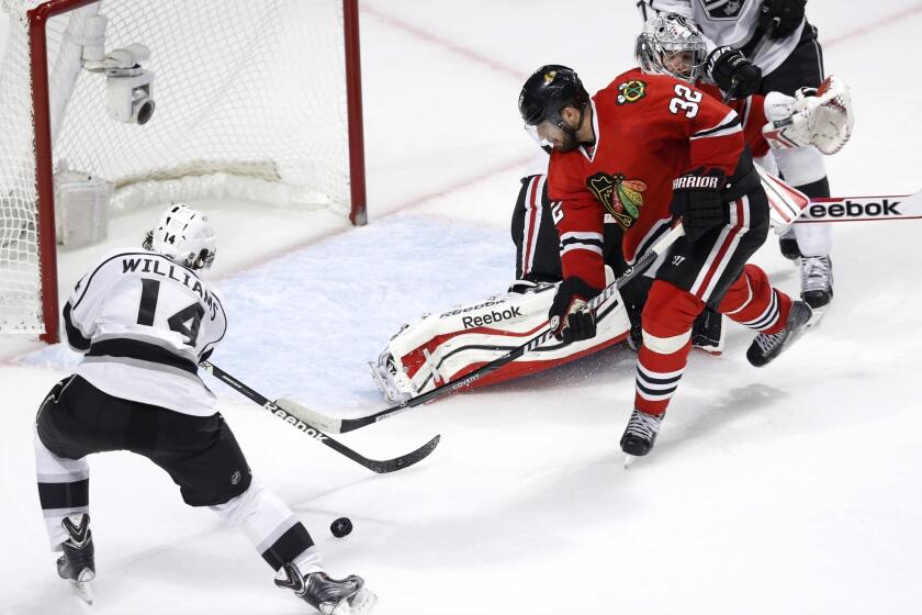 Blackhawks defenseman Michal Rozsival moves in to prevent Kings right wing Justin Williams from scoring into an open goal in the second period.