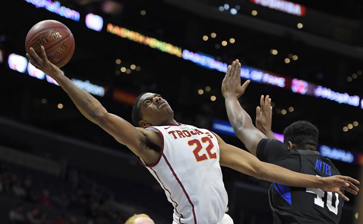 USC guard De'Anthony Melton, left, takes a shot next to BYU's Jamal Aytes on Dec. 3.