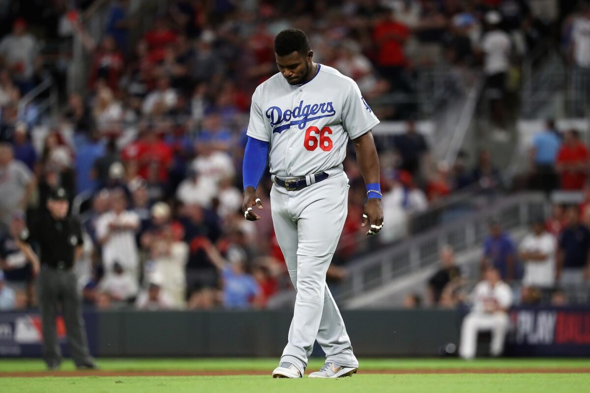 Yasiel Puig #66 of the Los Angeles Dodgers reacts after grounding out in the eighth inning against the Atlanta Braves during Game Three of the National League Division Series at SunTrust Park on October 7, 2018 in Atlanta, Georgia.