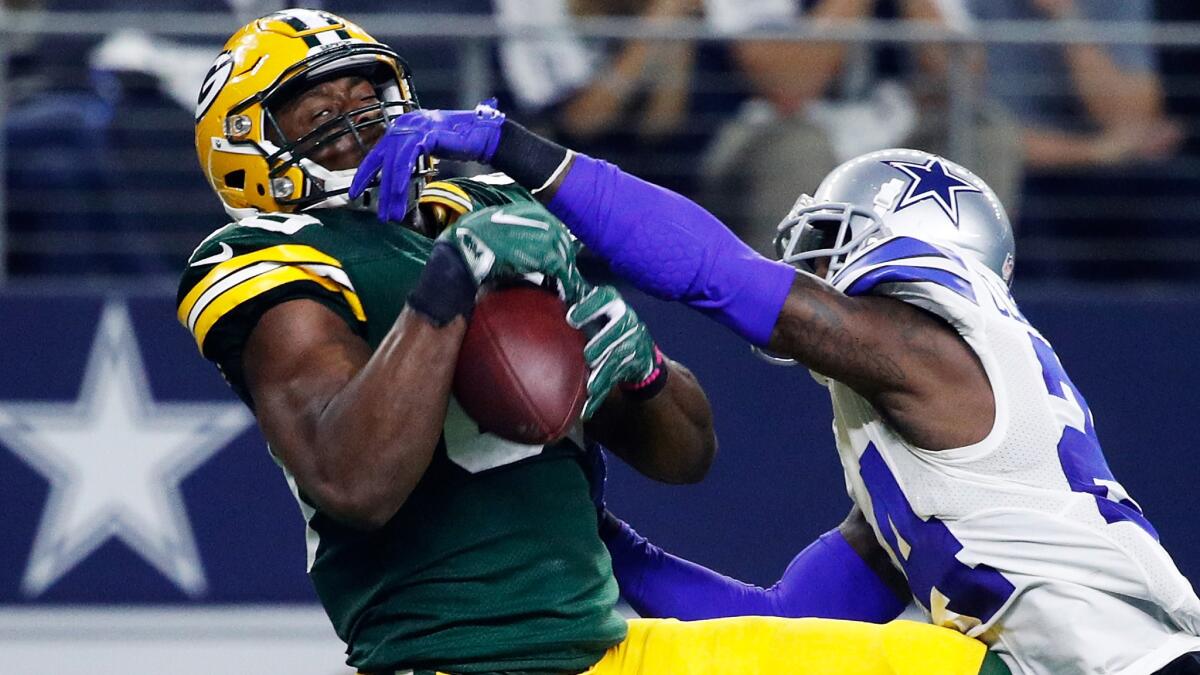 Packers tight end Jared Cook makes a difficult catch while defended by Cowboys defensive back Morris Claiborne during a divisional playoff game last season.