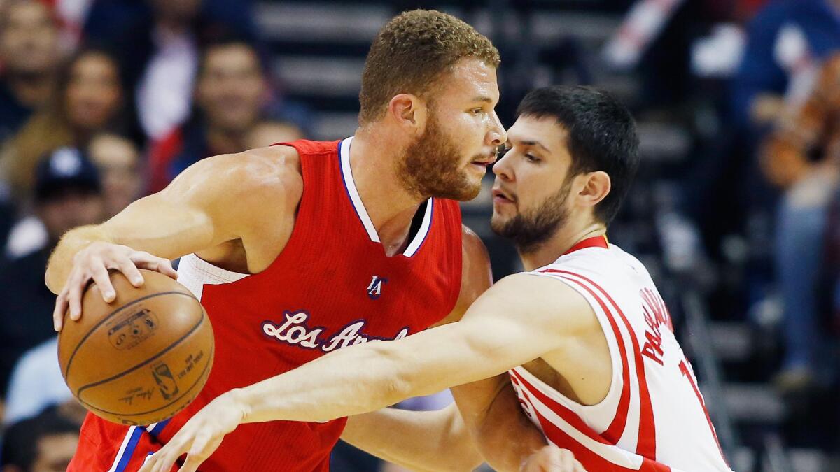 Clippers power forward Blake Griffin, left, tries to drive past Houston Rockets small forward Kostas Papanikolaou during the Clippers' win on Friday.