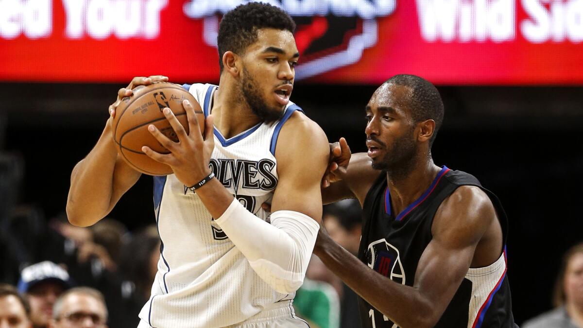 Clippers forward Luc Mbah a Moute defends in the post against Timberwolves center Karl-Anthony Towns on Saturday night.