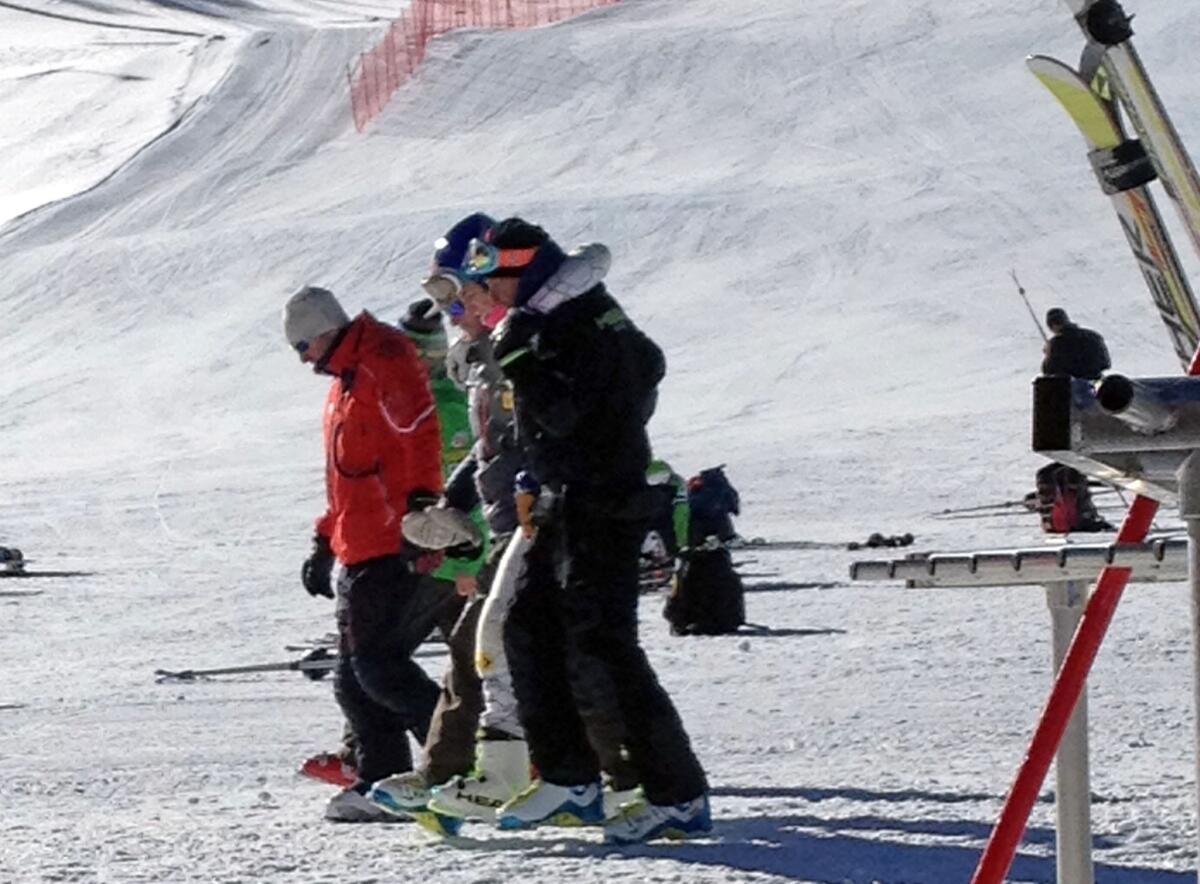 Lindsey Vonn, center, is helped off the slope after crashing during a run at Copper Mountain, Colo.
