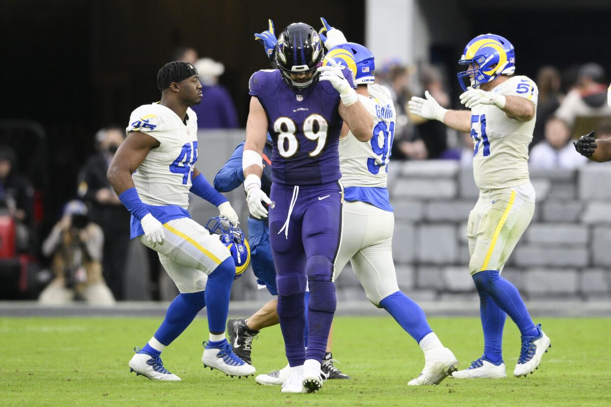 Baltimore Ravens tight end Mark Andrews (89) walks off as Los Angeles Rams players celebrate at the end of an NFL football game, Sunday, Jan. 2, 2022, in Baltimore. The Rams won 20-19. (AP Photo/Nick Wass)