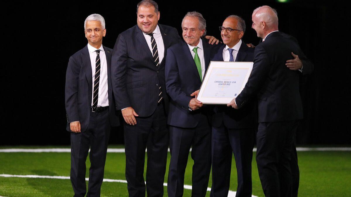 Sunil Gulati, left, poses with members of the United bid committee and FIFA president Gianni Infantino, right, after the U.S., Canada and Mexico were chosen to host the 2026 World Cup.