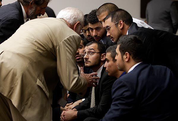 Muslim students gather with their attorney at the Central Justice Center on Friday after being found guilty of conspiring to disrupt and then disrupting a speech by the Israeli ambassador at UC Irvine last year. Eight of the 10 students were present for the verdict at the center in Santa Ana. The other two had permission by the court to be out of town.
