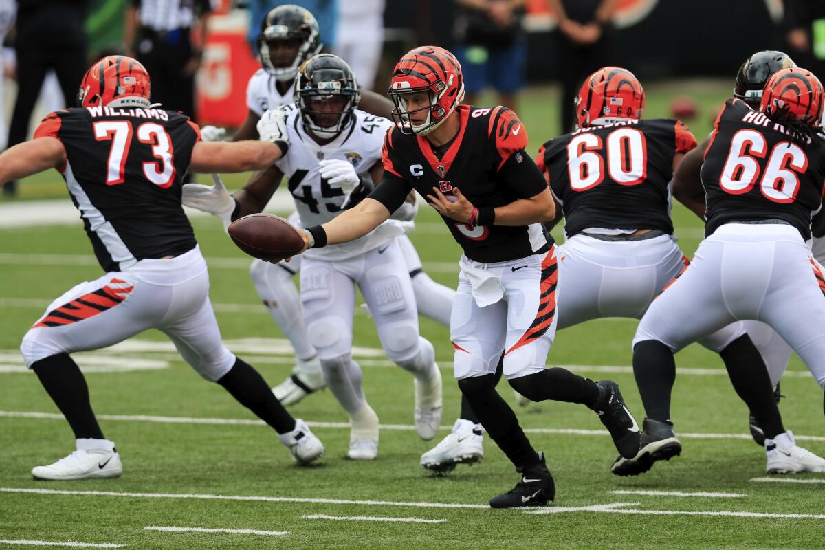 Cincinnati Bengals quarterback Joe Burrow looks to hand off the ball against the Jaguars on Oct. 4.