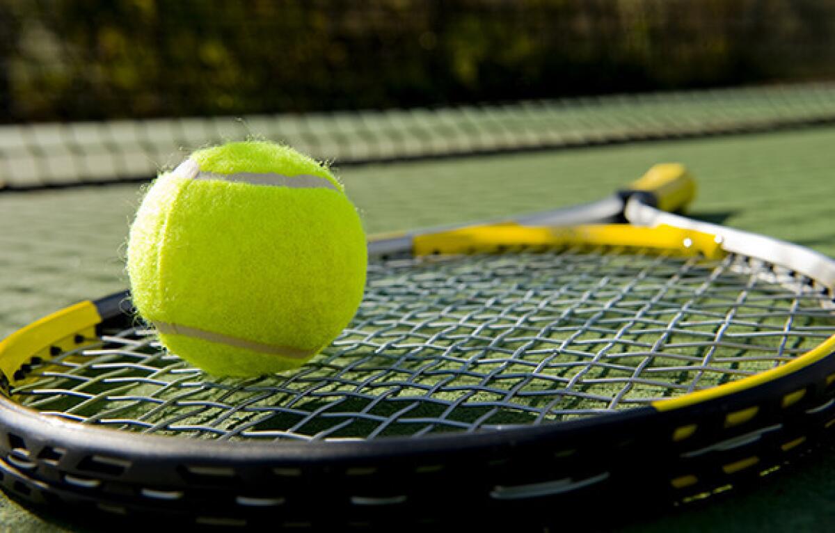 A tennis racket and new tennis ball.
