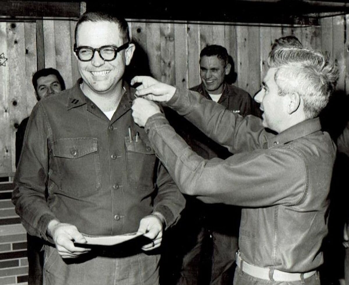 Navy meteorologist Paul Grisham, left, during his promotion to the rank of lieutenant in Antarctica, in 1968.