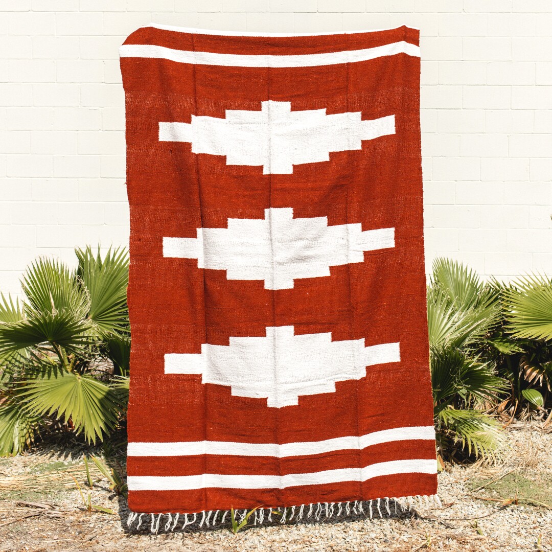 A red blanket  with a design of white diamonds
