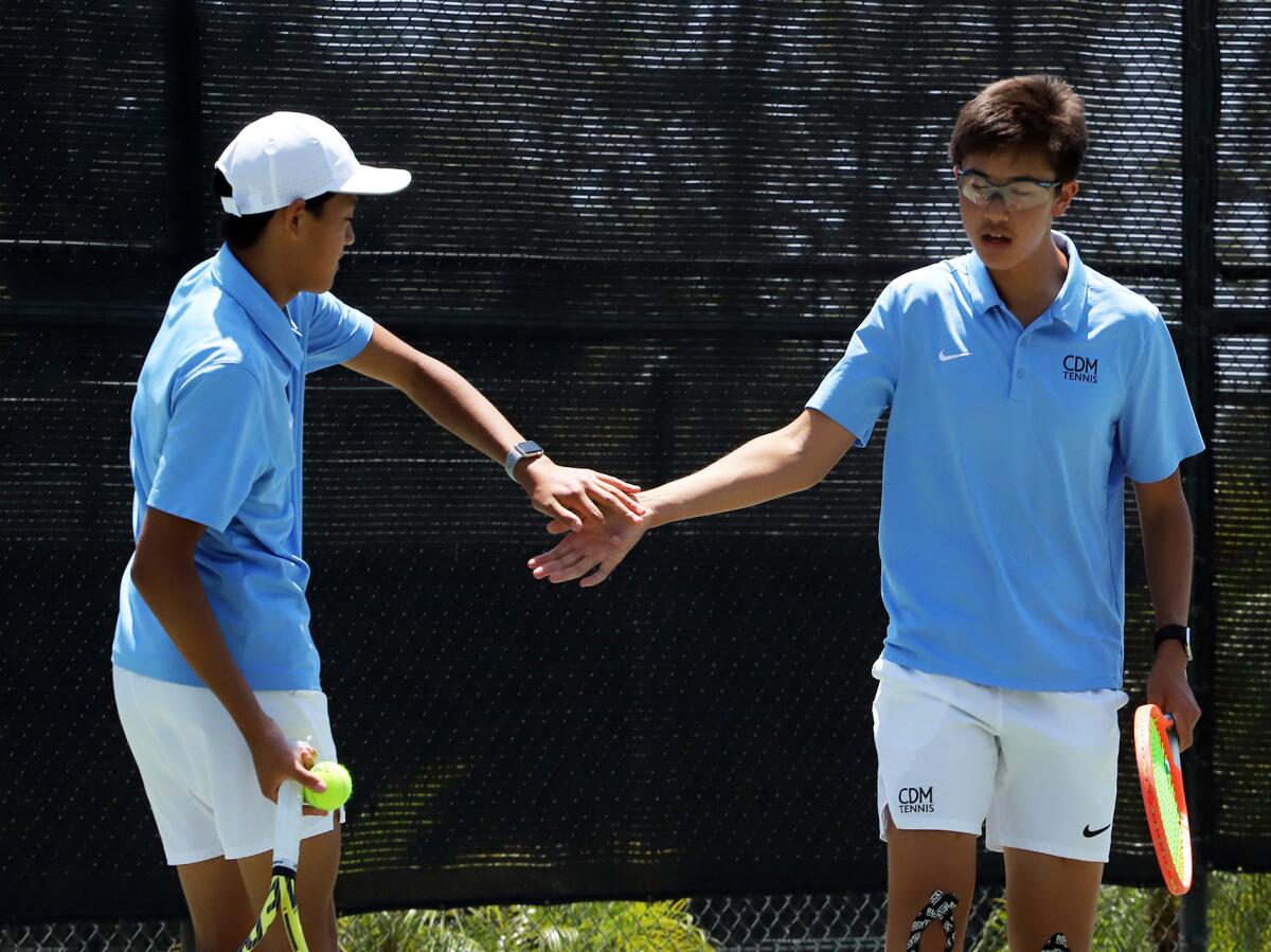 Corona del Mar's Lincoln Lin, left, and Tristan Pham high five against University during Friday's CIF title match.