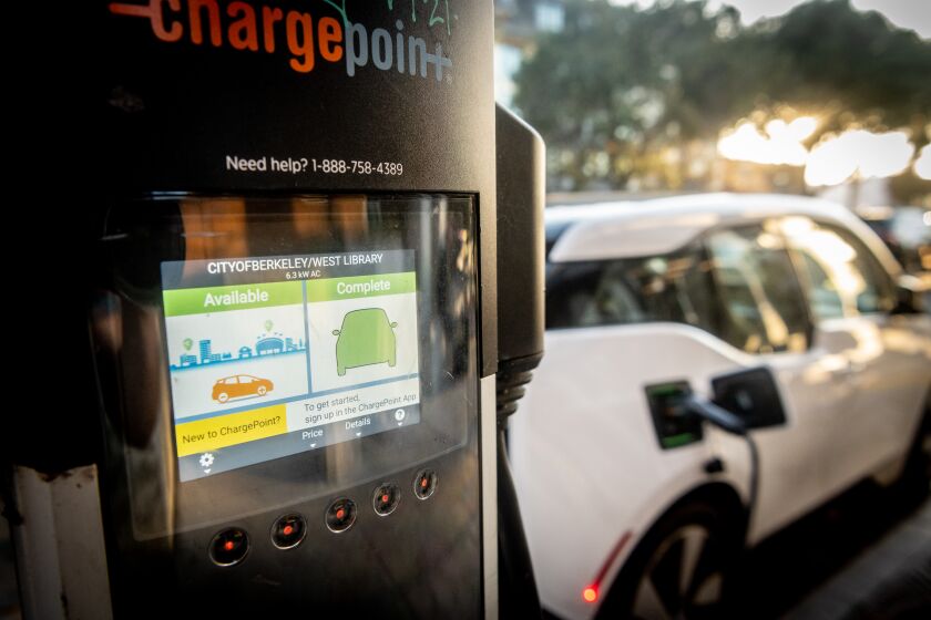 BERKELEY, CA - DECEMBER 01, 2021 - An electric vehicle charging station charges a vehicle with excess energy at the Berkeley Public Library West Branch in Berkeley, California on December 01, 2021. (Josh Edelson/for the Times)