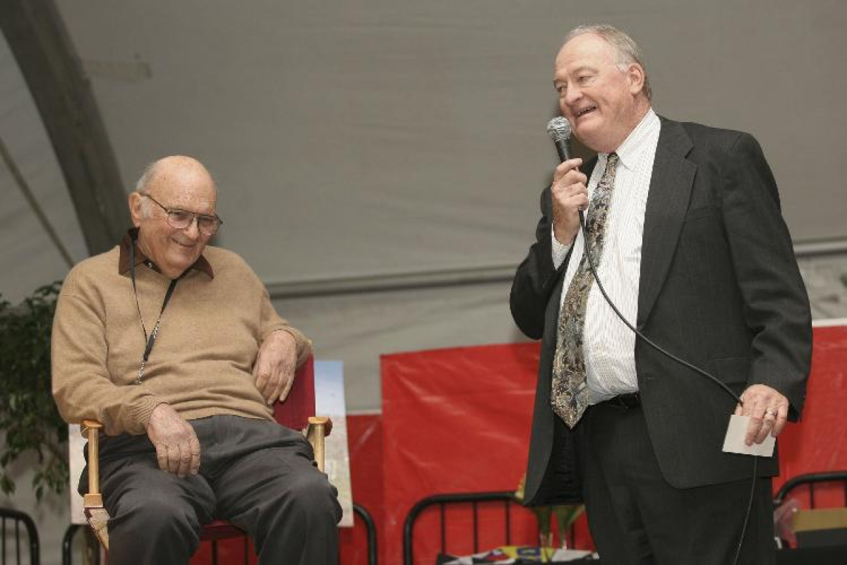 Los Angeles Times sports editor Bill Dwyre, right, speaks in front of Shav Glick during Glick's retirement party in 2006.