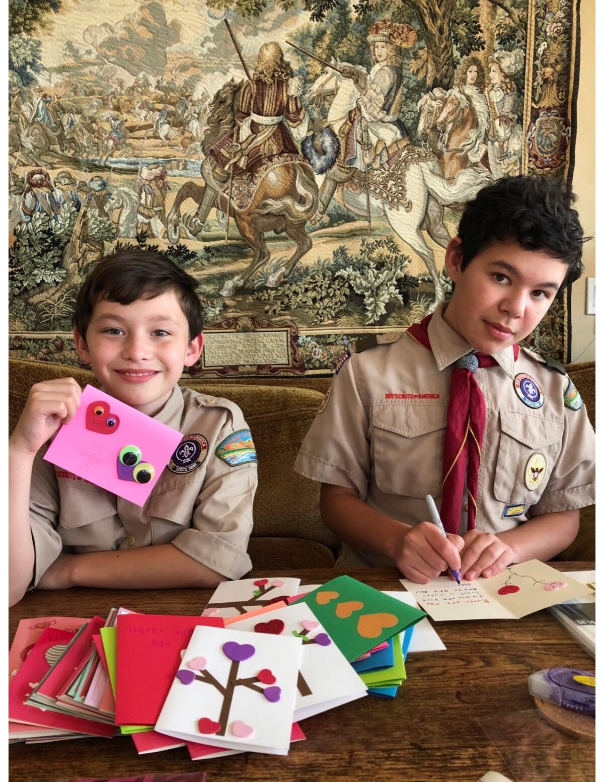 Benjamin Kruse, right, and Daniel Kruse make Valentine's Day cards to be given to seniors in long-term care facilities.