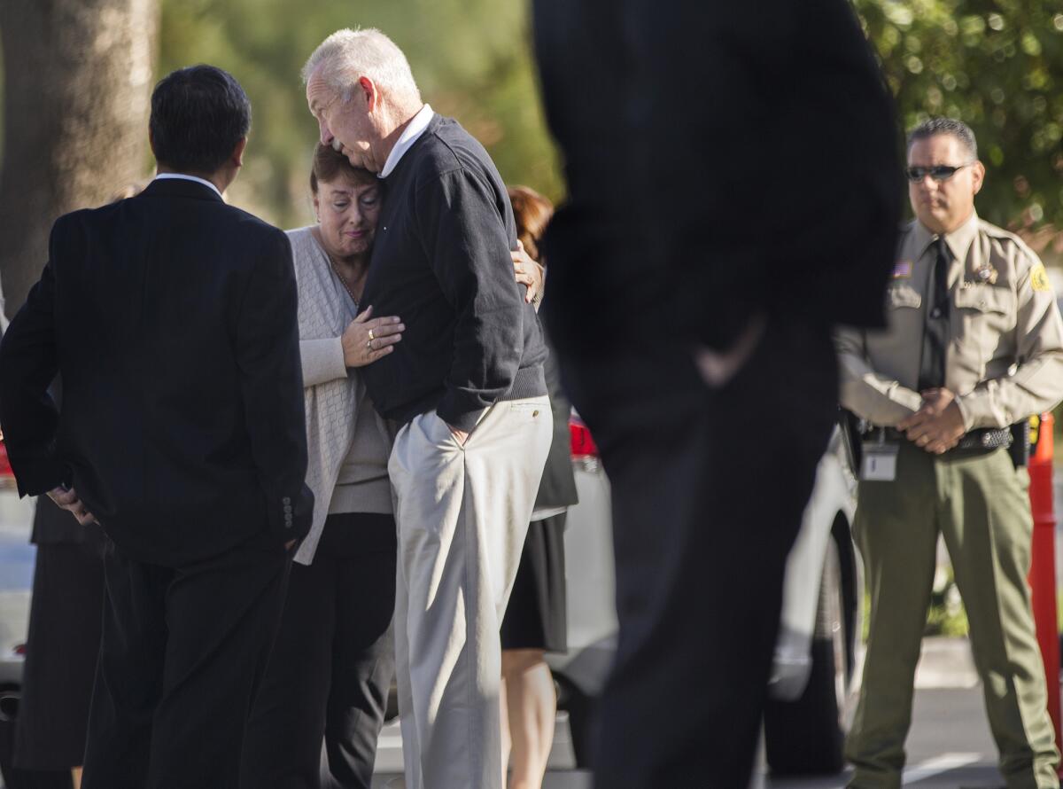 Family members console each other at the funeral for Damian Meins, who was killed in the San Bernardino shooting rampage, at St. Catherine of Alexandria Church in Riverside.