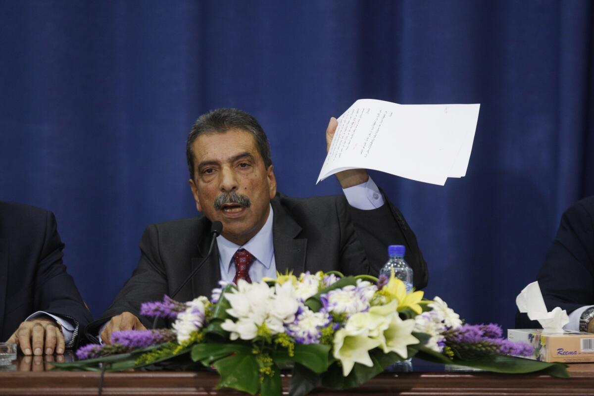 Palestinian investigator Tawfik Tirawi speaks at a news conference in the West Bank city of Ramallah.