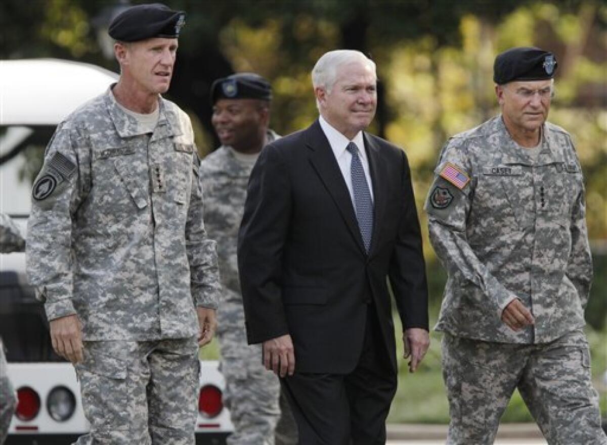 Gen. Stanley McChrystal, left, walks with Defense Secretary Robert M. Gates, center, and Army Chief of Staff Gen. George W. Casey Jr. as he is honored at a retirement ceremony at Fort McNair in Washington, Friday, July 23, 2010. McChrystal's illustrious career came to an abrupt end when he resigned as the top U.S. commander in Afghanistan after he and his staff were quoted in a Rolling Stone magazine article criticizing and mocking key Obama Administration officials. (AP Photo/J. Scott Applewhite)