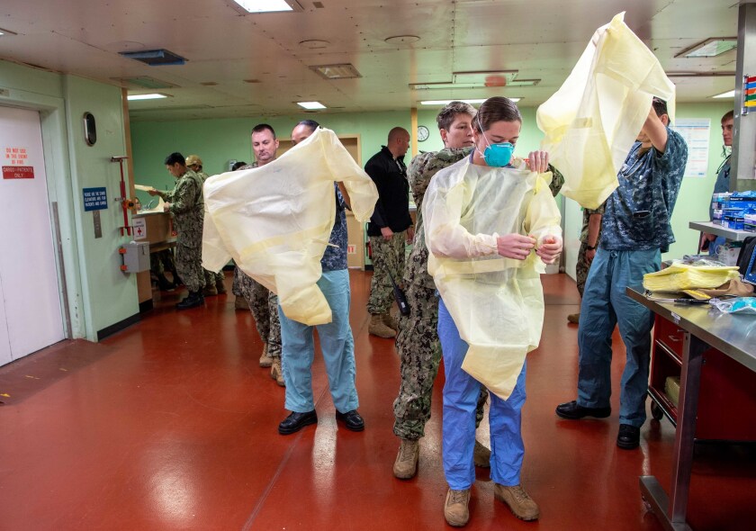 Sailors prepare to admit a patient aboard the hospital ship USNS Mercy in Los Angeles March 29.