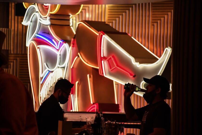 The Circa hotel and casino opened late last year in downtown Las Vegas and has seen a surge of customers in recent weeks as COVID restrictions have eased. Its neon cowgirl, Vegas Vickie, is a bow to local history.