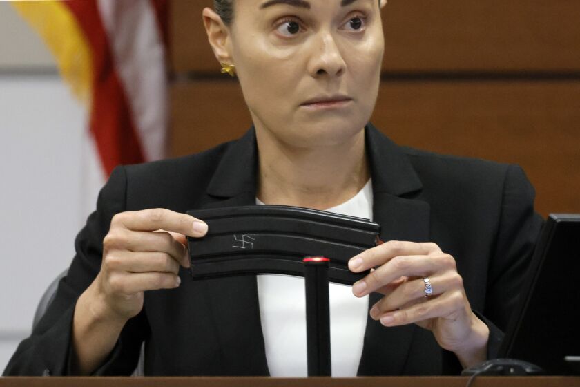 Broward Sheriff's Office Sgt. Gloria Crespo testifies about the weapon used by Marjory Stoneman Douglas High School shooter Nikolas Cruz in the 2018 shootings that has a swastika etched on the gun's magazine. This during the penalty phase of Cruz's trial at the Broward County Courthouse in Fort Lauderdale on Tuesday, Sept. 27, 2022. Sgt. Crespo took a photograph (for evidence purposes) of the gun used by Cruz after the shootings. Cruz previously plead guilty to all 17 counts of premeditated murder and 17 counts of attempted murder in the 2018 shootings. (Amy Beth Bennett/South Florida Sun Sentinel via AP, Pool)