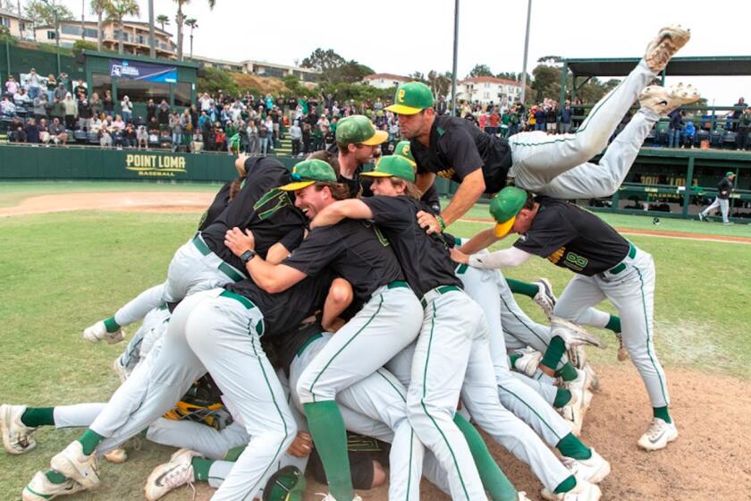 PLNU players dogpile on mound after beating Cal State Monterrey to advance to 2024 NCAA Division II national championships.