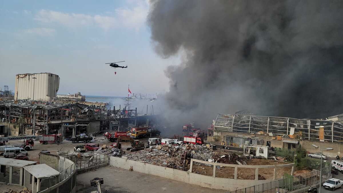 A helicopter helps fight a fire that erupted Thursday in Beirut's port.