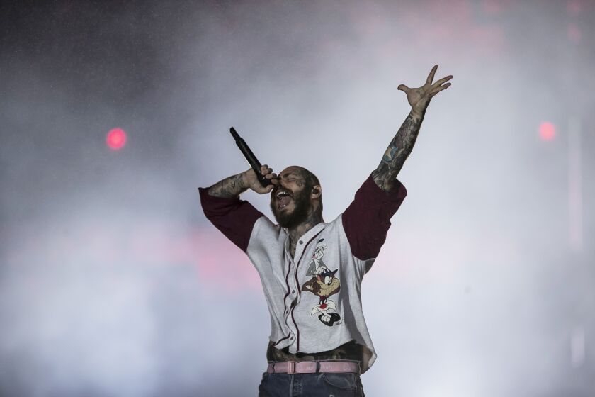 FILE - American rapper Post Malone performs during the Rock in Rio music festival in Rio de Janeiro, Brazil, Sept. 4, 2022. Malone went to the hospital on Saturday Sept. 24, 2022, after experiencing what he described on social media as difficulty breathing and stabbing pain, forcing him to postpone a scheduled show in Boston. He also spent time in the hospital last weekend after falling into a hole on stage at the Enterprise Center in St. Louis last weekend. (AP Photo/Bruna Prado, File)