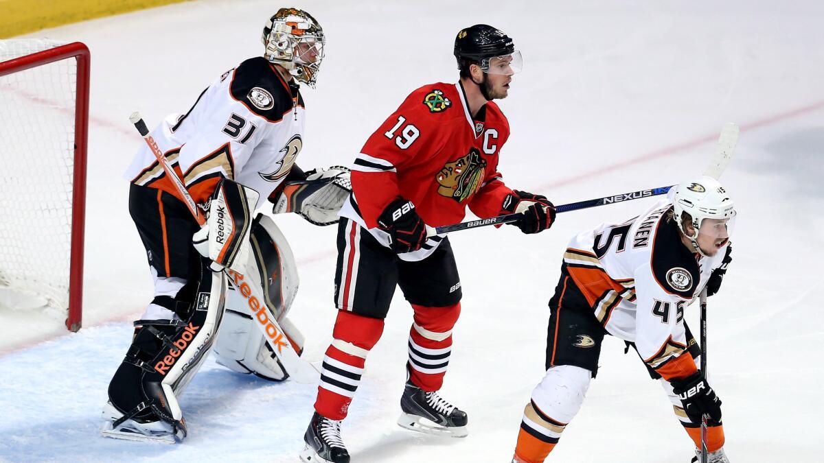 Chicago Blackhawks captain Jonathan Toews, center, stands between Ducks goalie Frederik Andersen and defenseman Sami Vatanen during the Ducks' 2-1 win in Game 3 of the Western Conference finals on May 21, 2015.