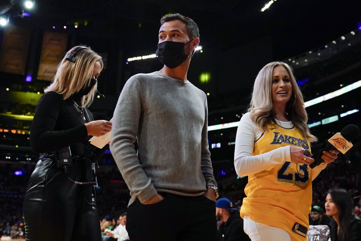 Kyle Larson, center, Nascar Cup Series champion, is introduced during the first half of an NBA basketball game between the Los Angeles Lakers and the Charlotte Hornets in Los Angeles, Monday, Nov. 8, 2021. (AP Photo/Ashley Landis)