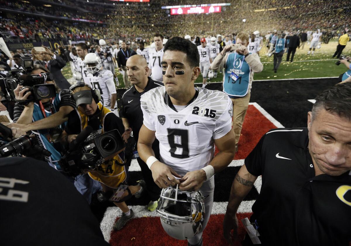 Ducks quarterback Marcus Mariota walks off the field at AT&T Stadium after the loss to Ohio State. It was perhaps the Heisman Trophy winner's final game if he opts to forgo his senior season and turn pro.