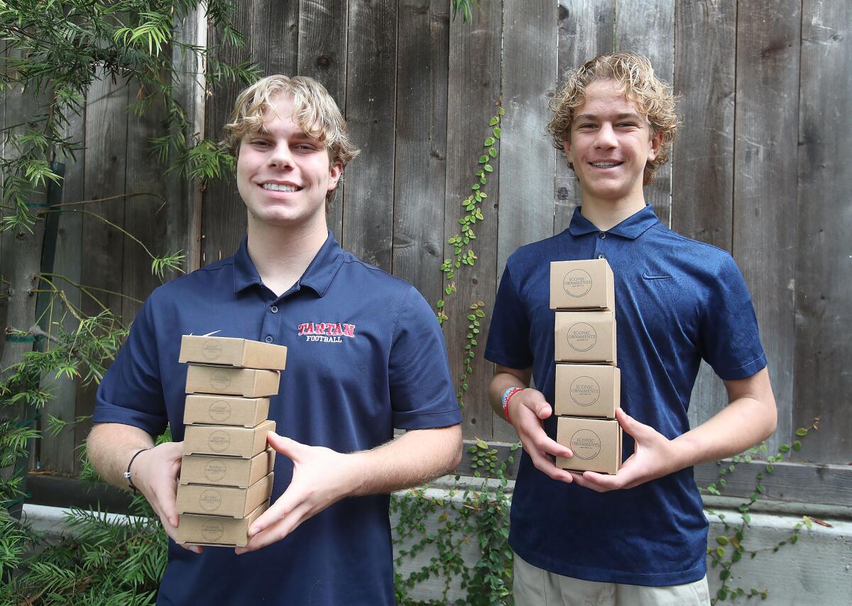 Iconic Ornaments founders Jackson and Sawyer Collins, from left, ship orders from their home office in Laguna Beach.