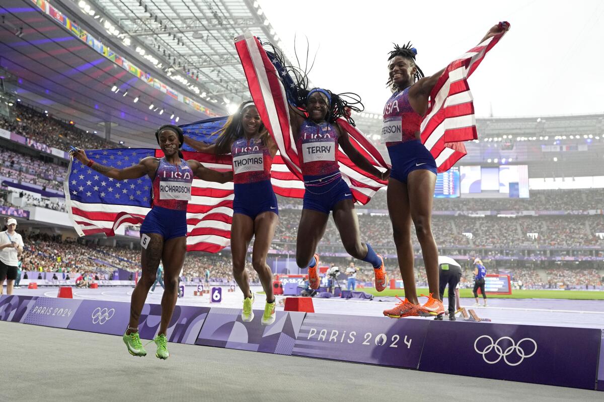 Americans Sha'carri Richardson, Gabrielle Thomas, Twanisha Terry and Melissa Jefferson pose after winning gold 