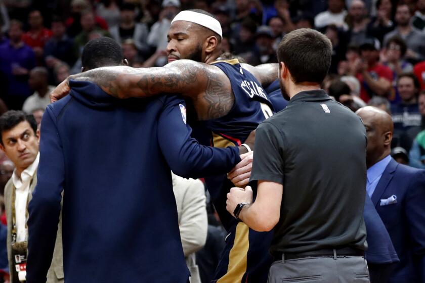 New Orleans Pelicans center DeMarcus Cousins (0) is helped off the court after injuring his left achilles tendon, in the second half of an NBA basketball game against the Houston Rockets in New Orleans, Friday, Jan. 26, 2018. The Pelicans won 115-113. (AP Photo/Gerald Herbert)