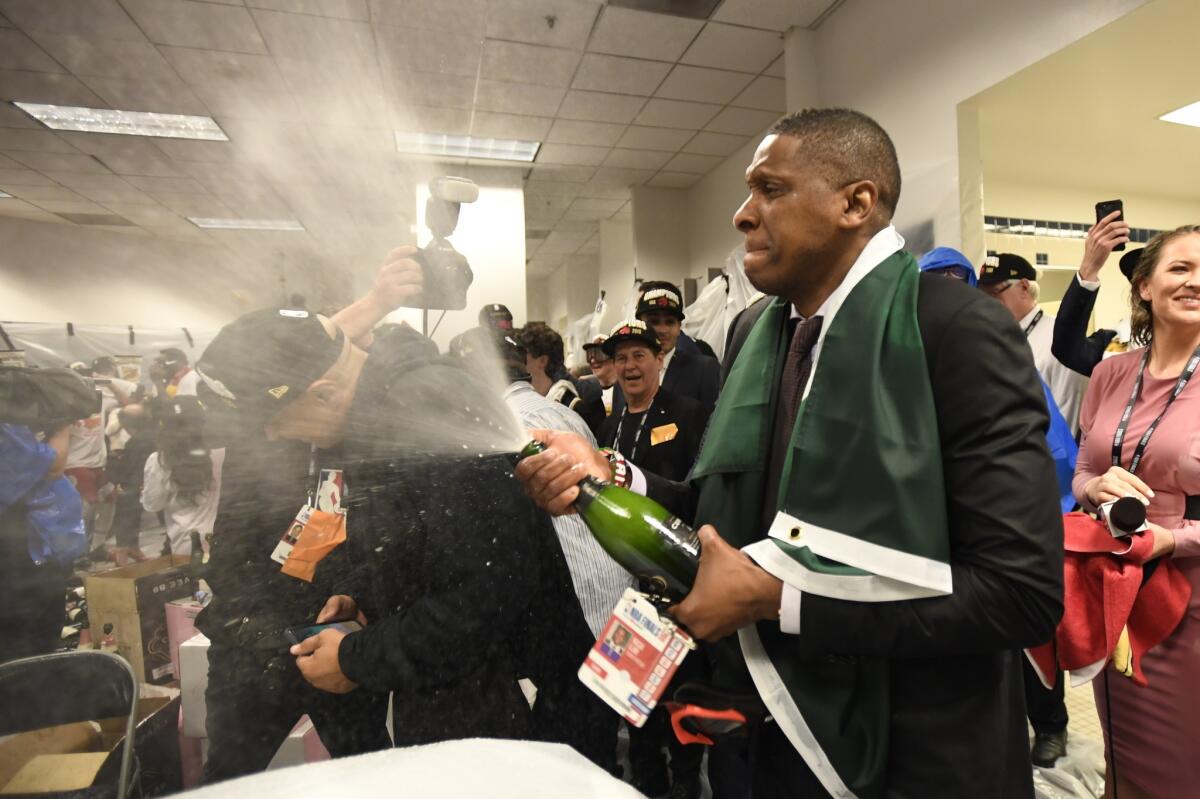 Raptors president Masai Ujiri sprays the locker room with champagne after the championship-clinching Game 6 win over Golden State.