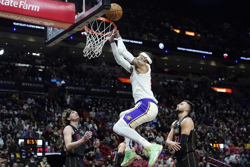 Los Angeles Lakers forward Carmelo Anthony, center, misses an attempted dunk .