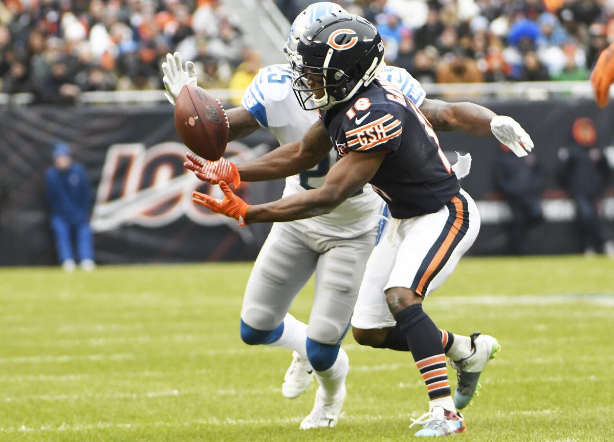 Chicago Bears wide receiver Taylor Gabriel tries to make a catch in front of Detroit Lions safety Will Harris.