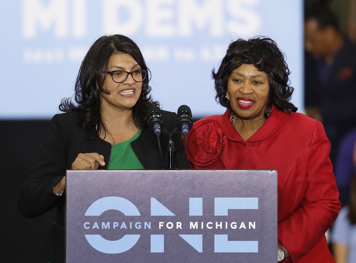 FILE - In an Oct. 26, 2018, file photo, Rashida Tlaib, left, then-Democratic candidate for the Michigan's 13th Congressional District, and Brenda Jones speak during a rally in Detroit. Tlaib's approach to governing as an unapologetic fighter, taking aim at the status quo alongside three other first-term congresswomen of color who make up the "squad" has made her a target of the GOP and her own party. Now the Michigan Democrat is the squad's most vulnerable member, as she faces Detroit City Council President Brenda Jones in the Aug. 4 primary. (AP Photo/Paul Sancya, File)