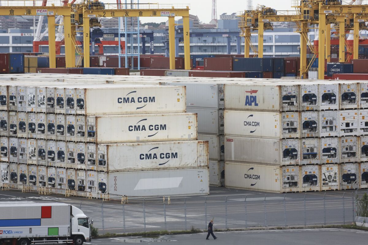 Containers are placed at a port in Yokohama, south of Tokyo on Sept. 7, 2021. Japan’s economy shrank at a 3% annual rate in the July-September quarter, as private consumption and auto production took a hit from the ongoing efforts to curb the coronavirus pandemic, according to data released on Monday, Nov. 15, 2021. (AP Photo/Koji Sasahara)