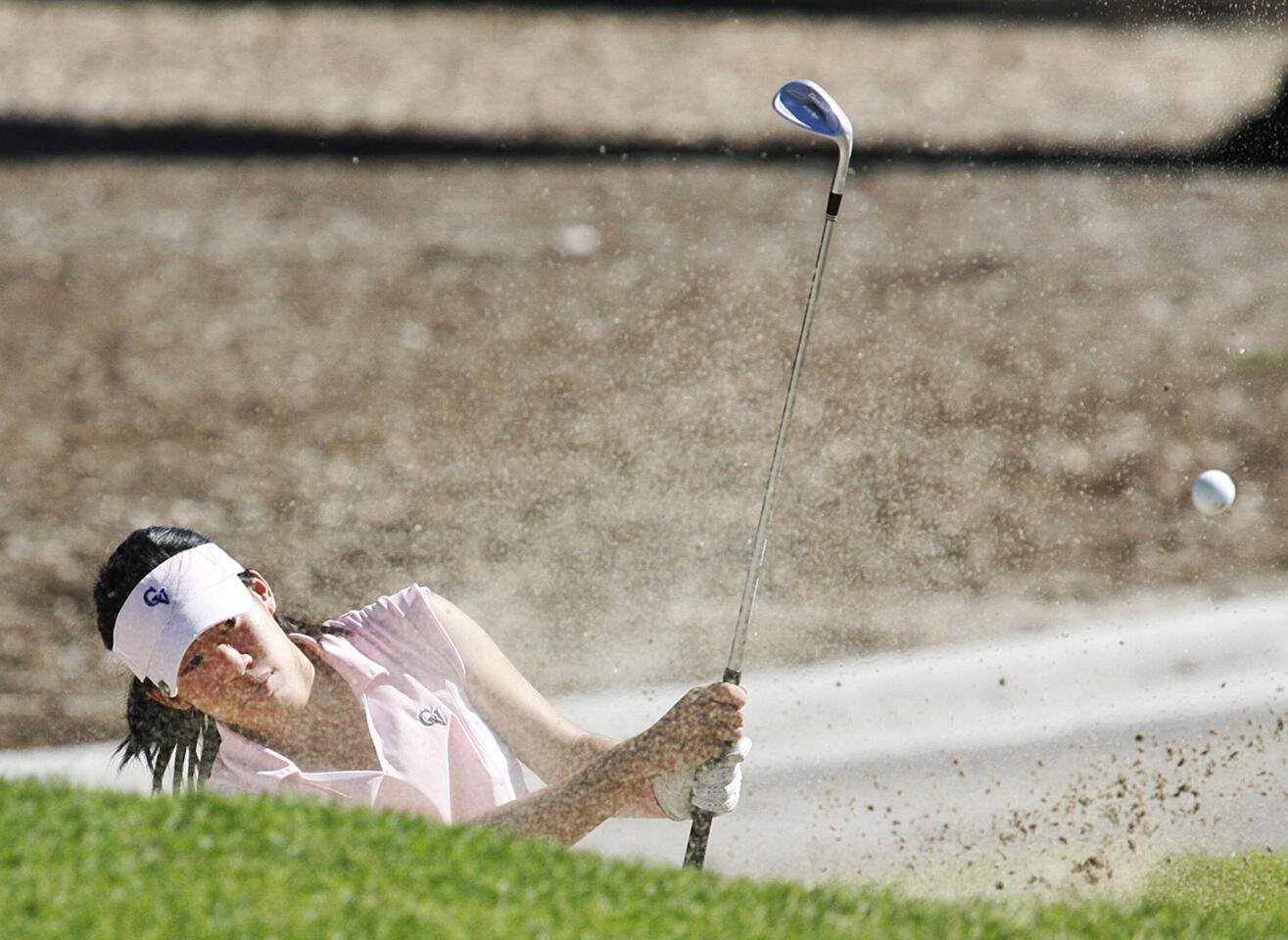 Crescenta Valley's Joelyn Chia hits out of the bunker next to the second green for the Pacific League girls golf championship at Brookside Golf Course in Pasadena on Wednesday, October 17, 2012.